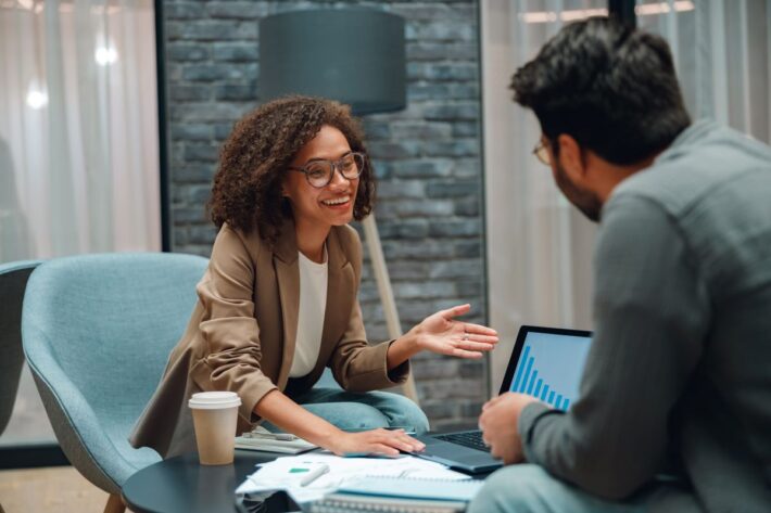Two workers talking in an open space